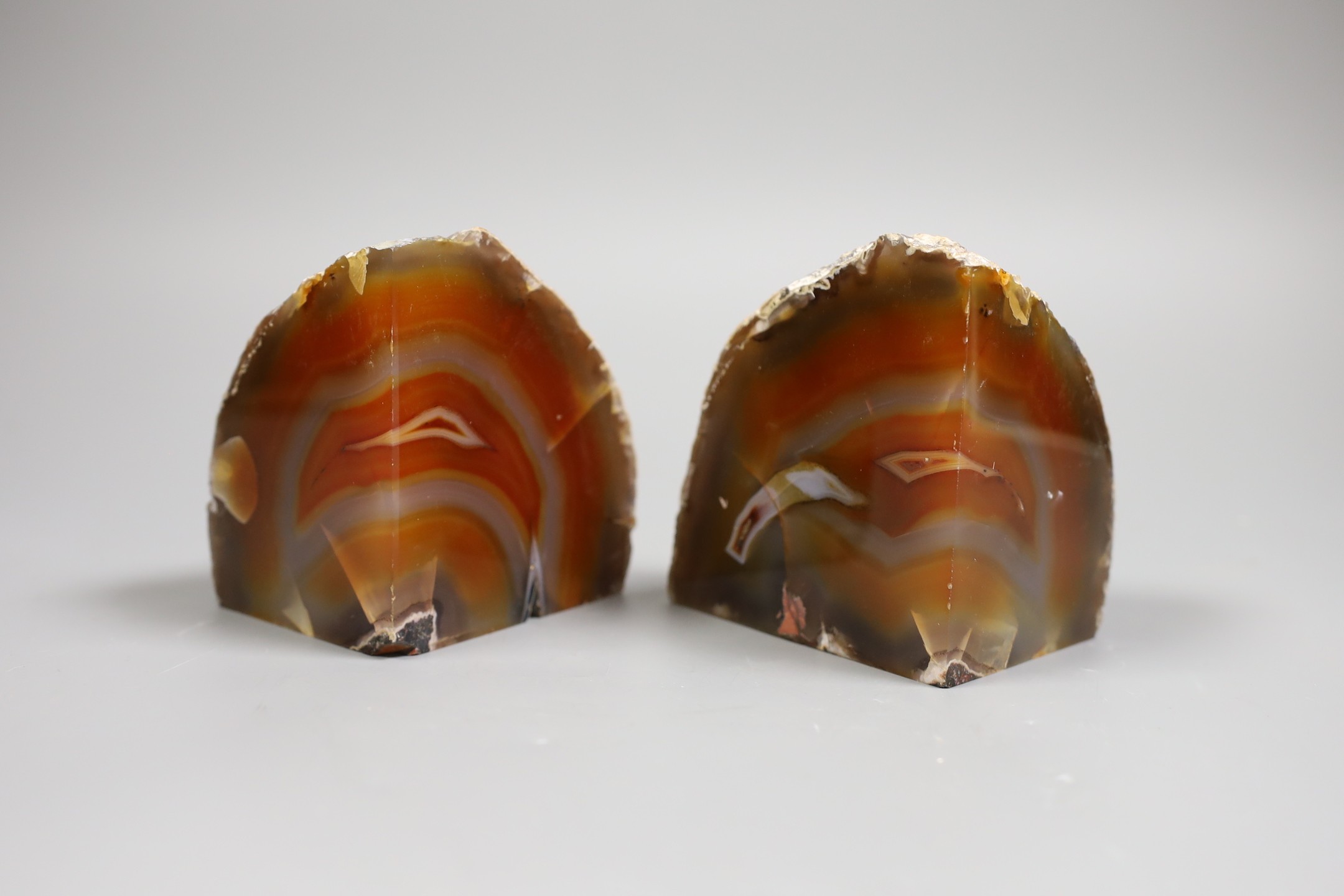 A pair of banded agate geode book ends, 10.5 cms high